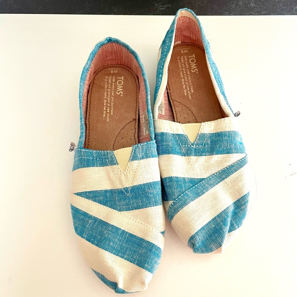 Tom’s slip on blue/white strip in size 8.